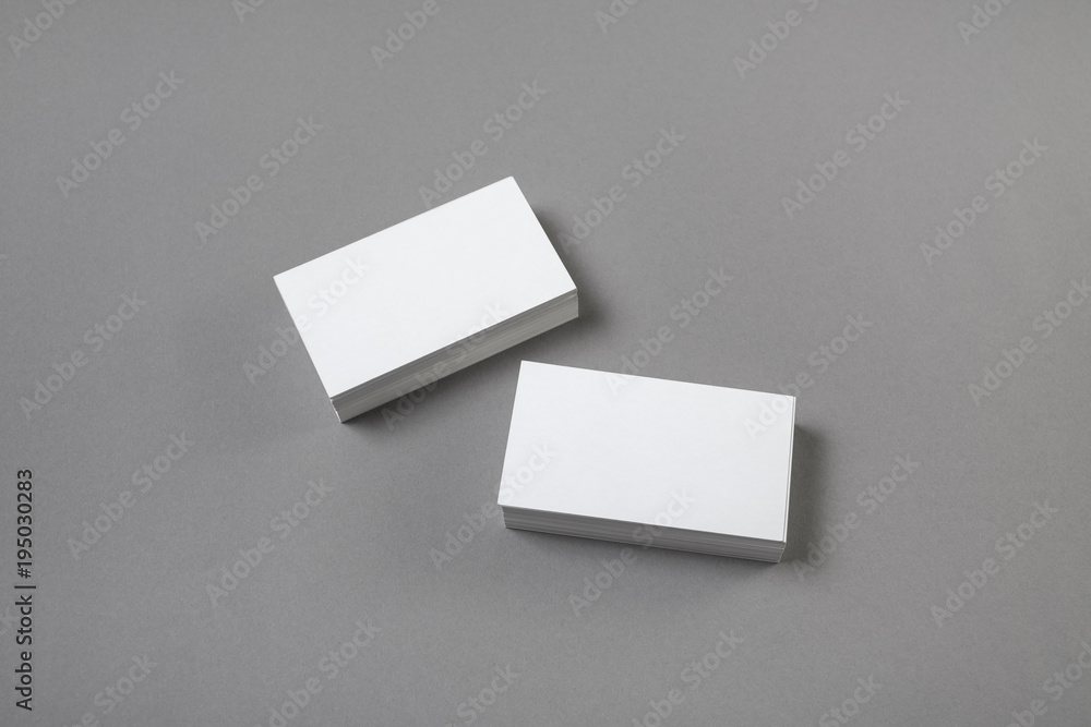 Blank business cards on grey paper background. Template for branding identity. Studio shot. Blank business cards on grey paper background. Template for branding identity. Studio shot.