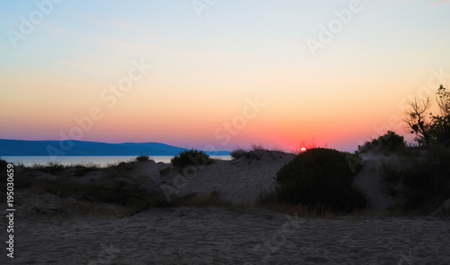 Scenic morning dawn over the sandy hills and the sea. Black sea coast.
