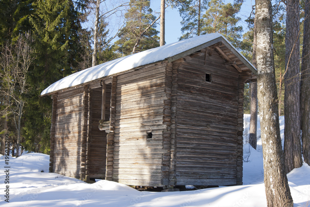 Old wooden house on the Finnish forest in winter