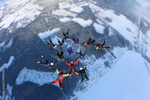 A group of skydivers is in the sky.
