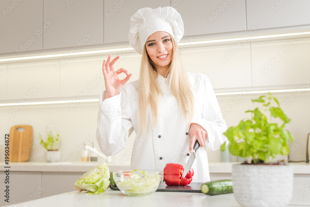 Young woman chef cooking cake in kitchen Young woman chef cooking cake in kitchen