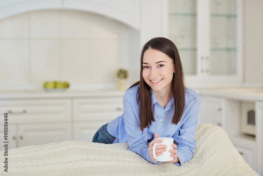 Young girl with a cup of hot drink in the kitchen. Young girl with a cup of hot drink in the kitchen.