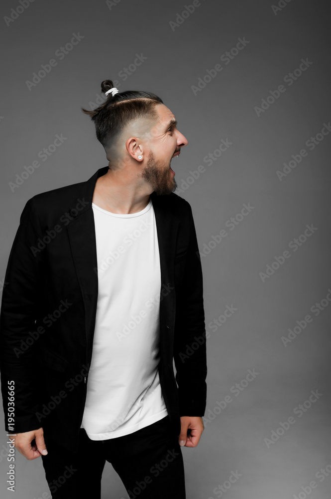 emotional man in a shirt with black hearts on a gray background
emotional man in a shirt with black hearts on a gray background