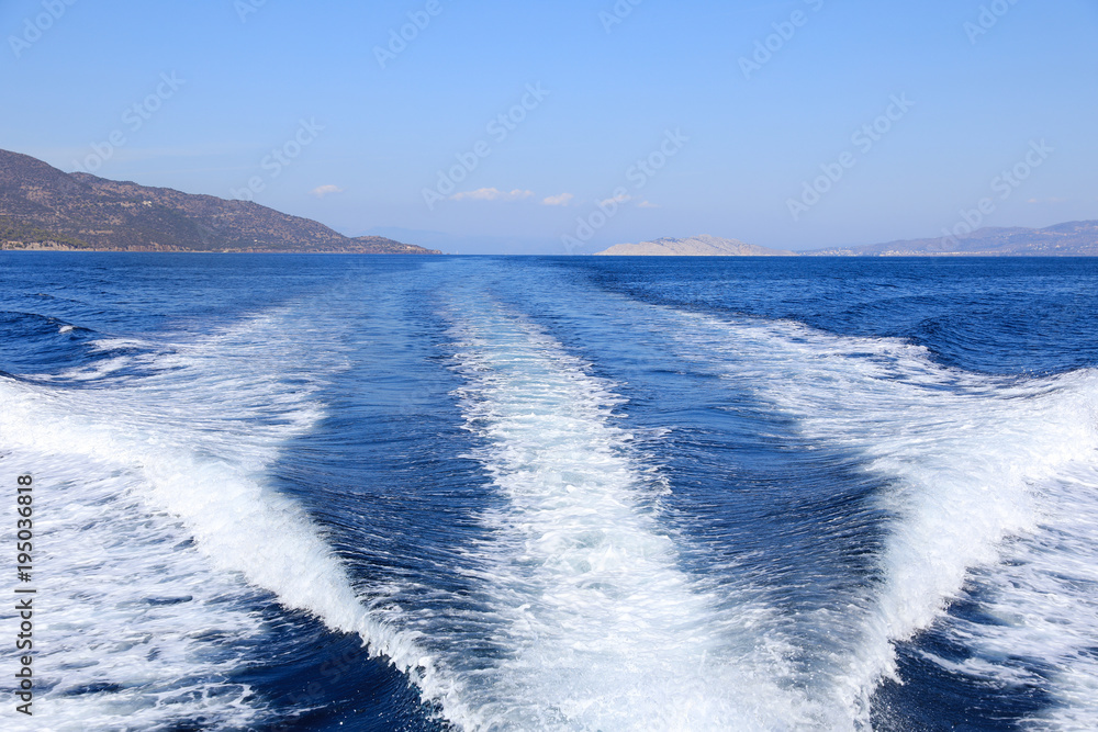 Beautiful sea during summer holidays. Back view from the yacht on a sunny day. Saronic Gulf, Greece. Beautiful sea during summer holidays. Back view from the yacht on a sunny day. Saronic Gulf, Greece.