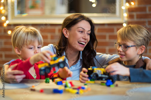 Mother and Children Playing with Blocks At Home 