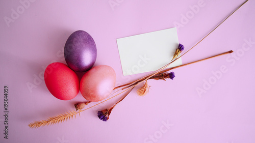 violet, gold and pink egg, dry branches on a lilac background. a collage by great Easter
