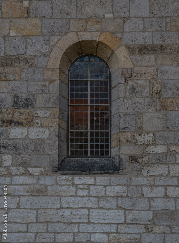 The old and ancient window in stone wall