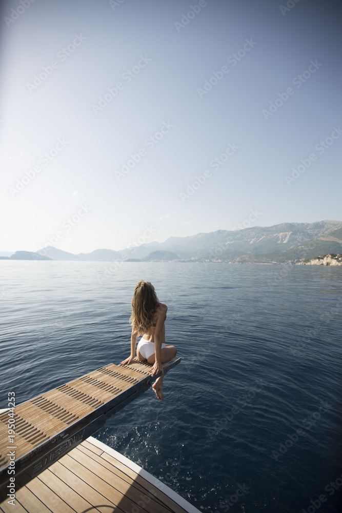 Pretty woman relaxing on the yacht on sea at sunny day Pretty woman relaxing on the yacht on sea at sunny day