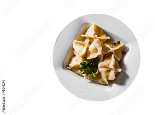 Meat dumplings - russian pelmeni, ravioli with meat on plate isolated on white background. with copy space. top view