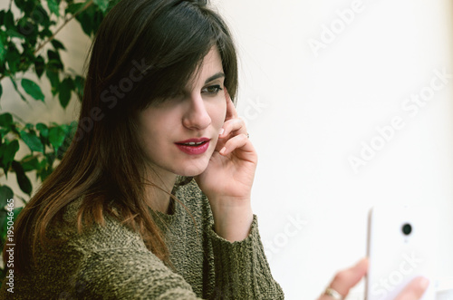 Hipster cool girl taking picture on smartphone self-portrait