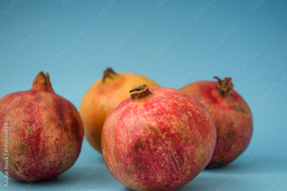 juicy pomegranate on a blue background juicy pomegranate on a blue background