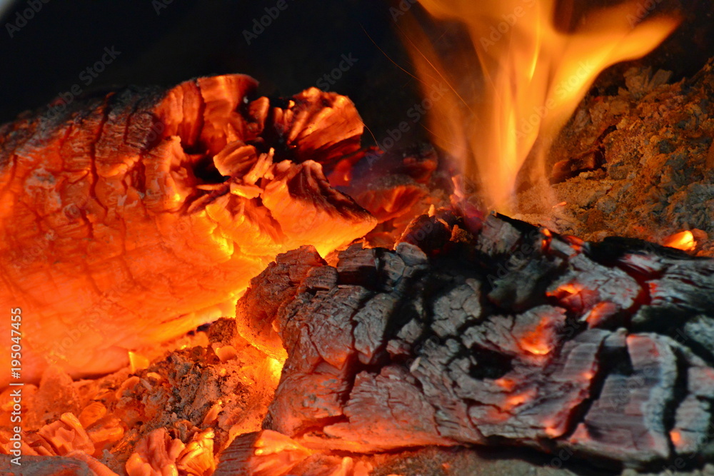 Fototapeta premium Fire burning from a log in the home fireplace. The firewood burns in the oven and gives heat.