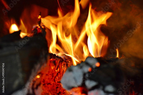 Fire burning from a log in the home fireplace. The firewood burns in the oven and gives heat.