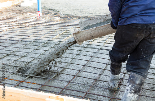 Photography Closeup shot of concrete casting on reinforcing metal bars of floor in industria