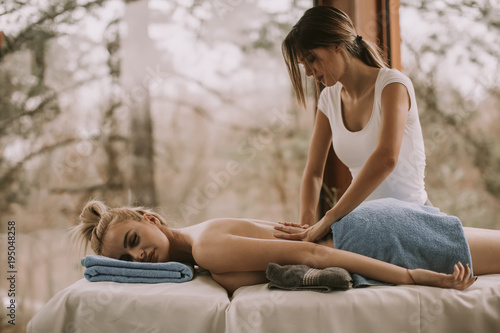 View at beautiful blond woman enjoying a massage at the health spa
