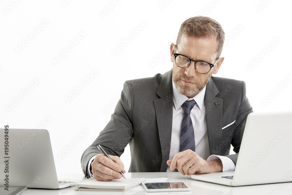 Businessman using laptops while working against white isolated background. Businessman using laptops while working against white isolated background.