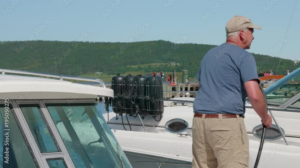 Man cleans their motor boat off Man cleans their motor boat off