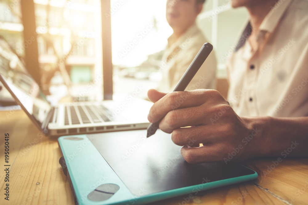 Men are using a pen mouse to work. Men are using a pen mouse to work.