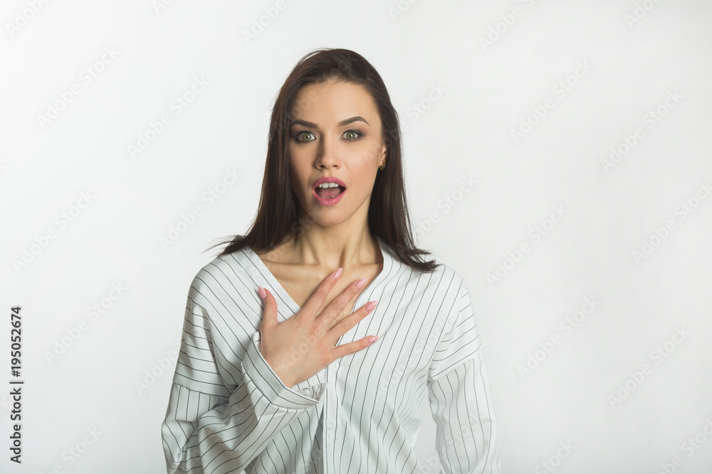 beautiful young girl on a white background in a light shirt with a frightened face beautiful young girl on a white background in a light shirt with a frightened face