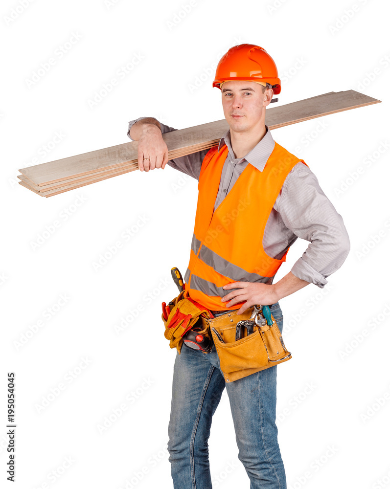 builder in a helmet holding floorboards and looking at camera over white wall background. repair, construction, building, people and maintenance concept. builder in a helmet holding floorboards and looking at camera over white wall background. repair, construction, building, people and maintenance concept.