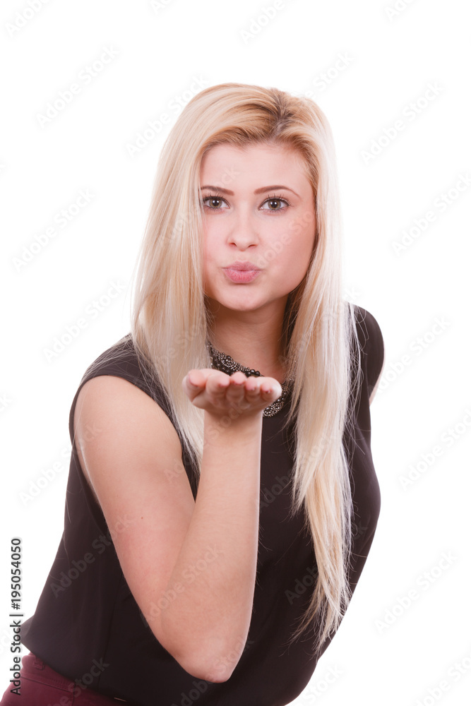 Blonde woman sending air kiss on palm hand Blonde woman sending air kiss on palm hand