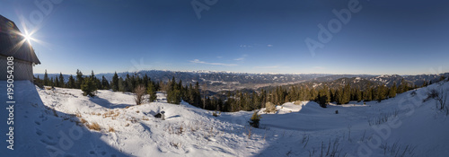 Wide panoramia from snowy summit of mountain Rennfeld with hut photo