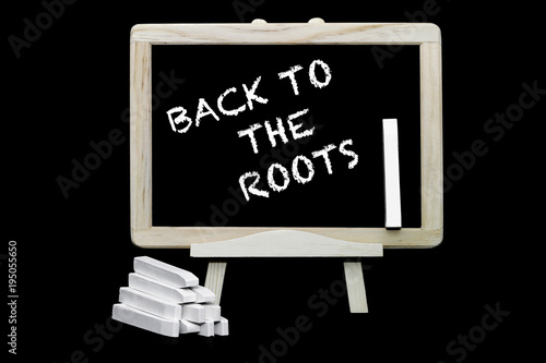 Back to the roots slogan on a blackboard