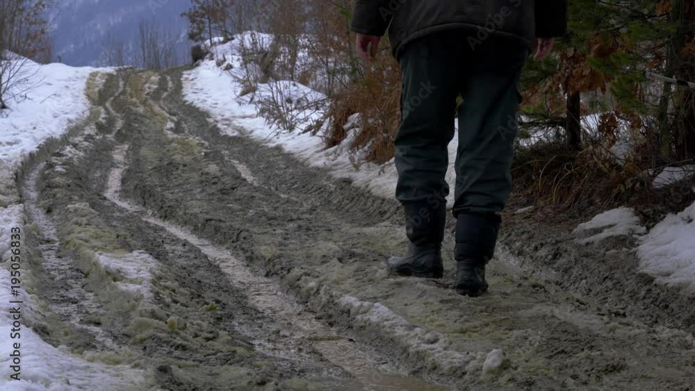 Man goes through the wet forest path snow melted - (4K) Man goes through the wet forest path snow melted - (4K)