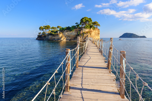 Wooden bridge from Agios Sostis leading to small rocky island. Bay of Laganas  Zakynthos island  Greece.