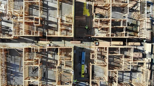 Top Down view of construction workers building apartments 