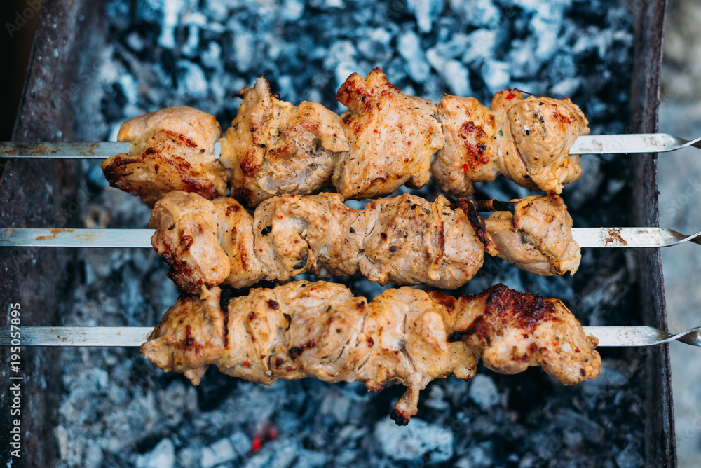 Three skewers of fried shish kebab Three skewers of fried shish kebab