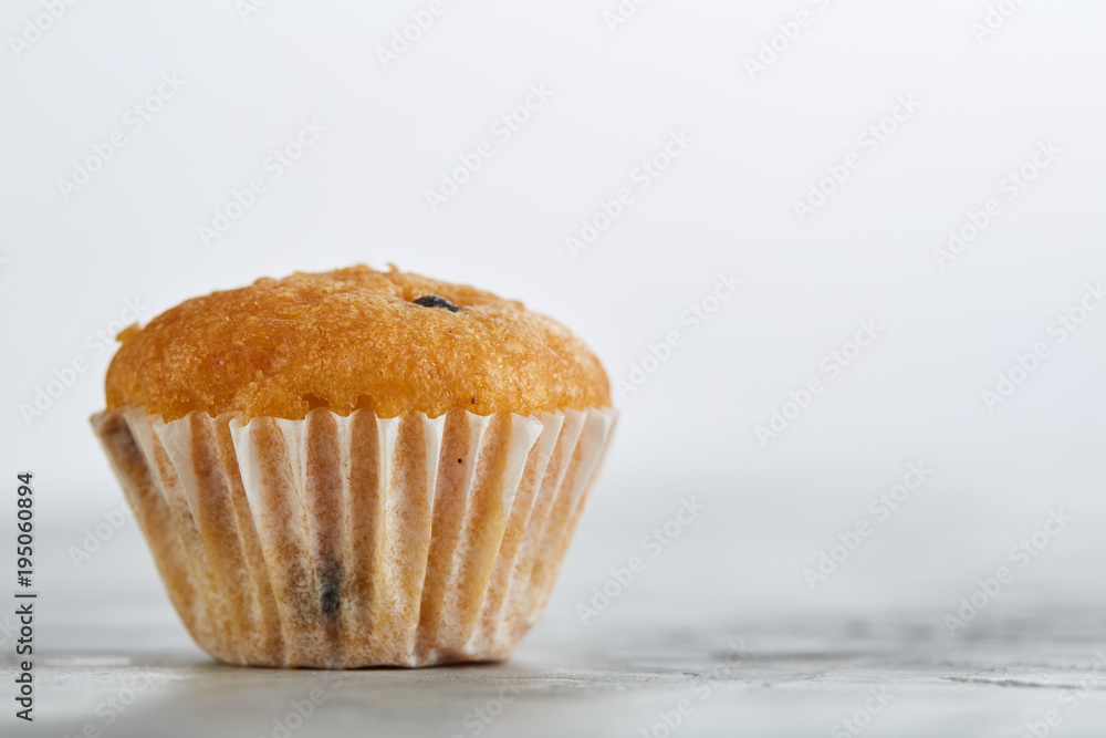 Tasty muffins arranged in pattern on light textured background, close-up, shallow depth of field, selective focus. Tasty muffins arranged in pattern on light textured background, close-up, shallow depth of field, selective focus.