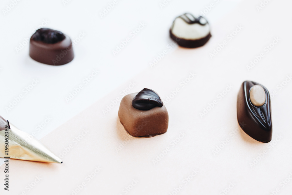 Various kinds of chocolate luxury candy. Pastel background.