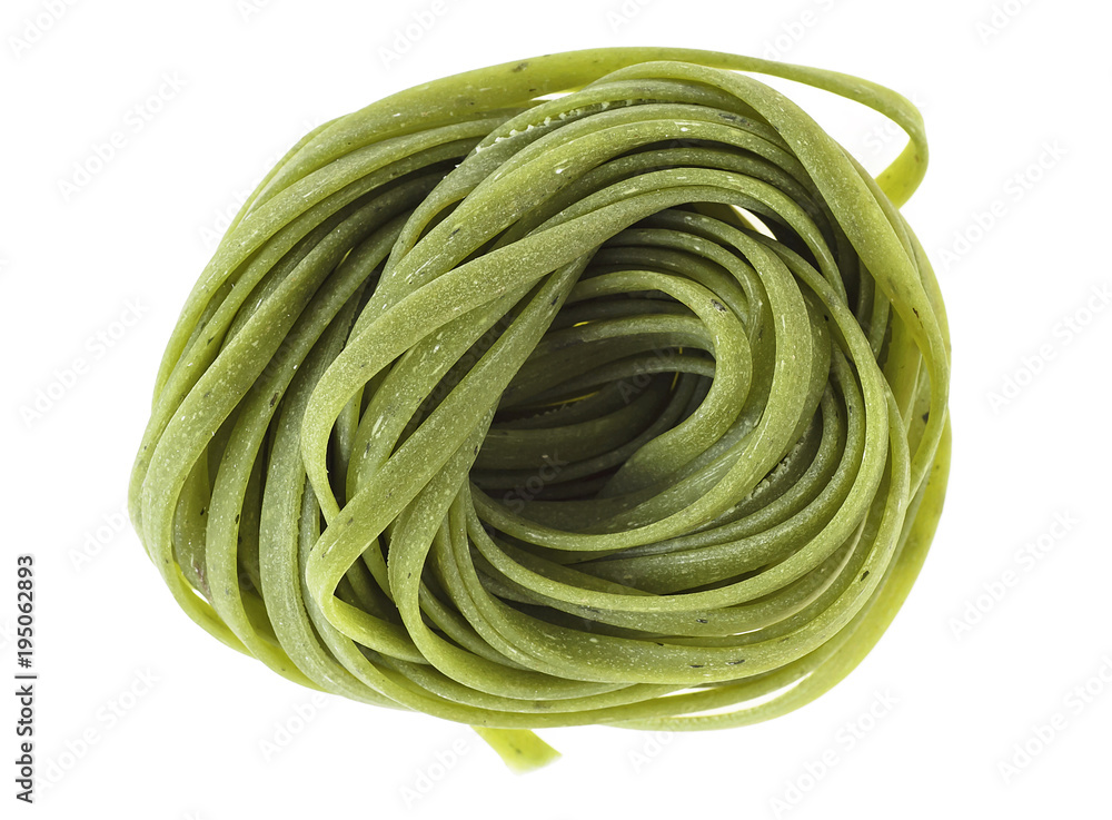 Nest of green tagliatelle isolated on white background, top view