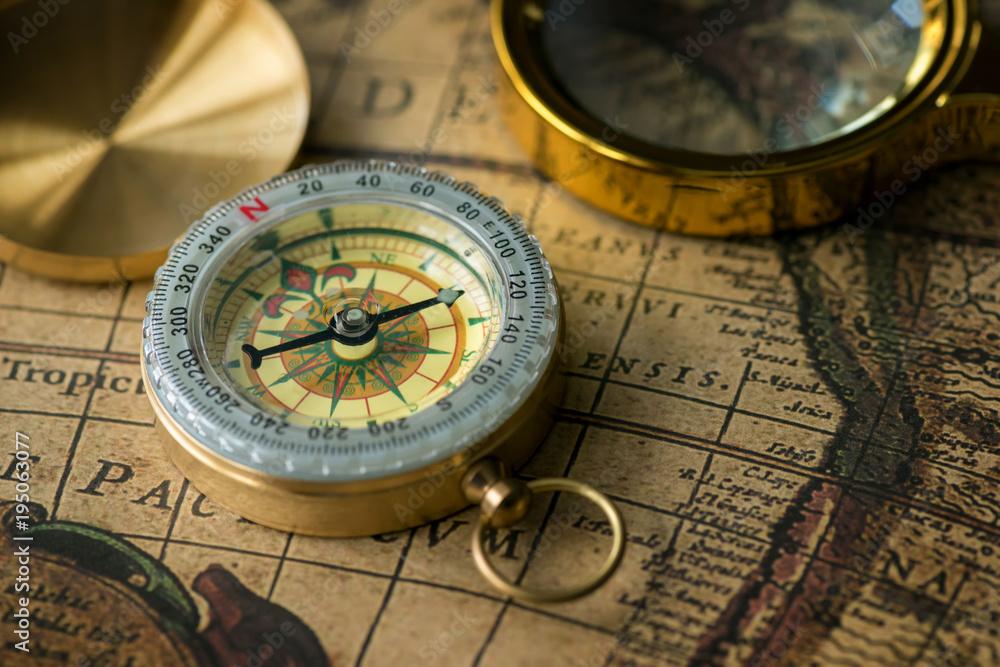 Retro compass with old map and magnifier Retro compass with old map and magnifier