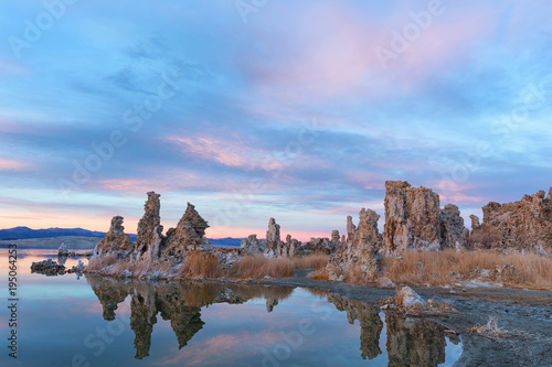 Sunset at Mono lake  California. Bizarre calcareous tufa formation on the smooth water of the lake.