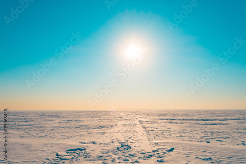 Canvastavla Road in the snow in the winter snowy desert in the turquoise sky the bright sun shines