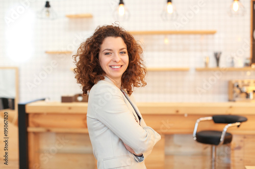 Young woman standing in cafe. Small business owner portrait