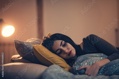 Woman abandoned by her lover, crying and depressed, alone in her bed