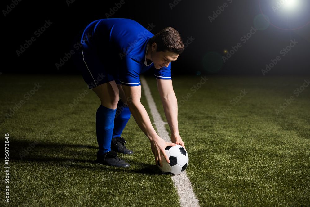 Fototapeta premium Soccer player about to kick the football