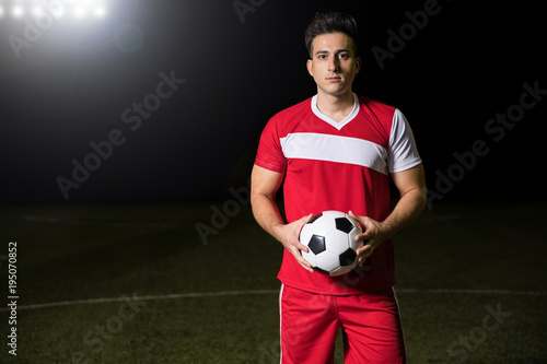 Footballer on field with ball © AntonioDiaz