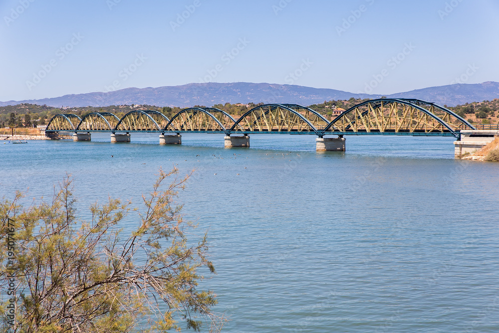 Obraz premium Railway bridge over water in portuguese landscape