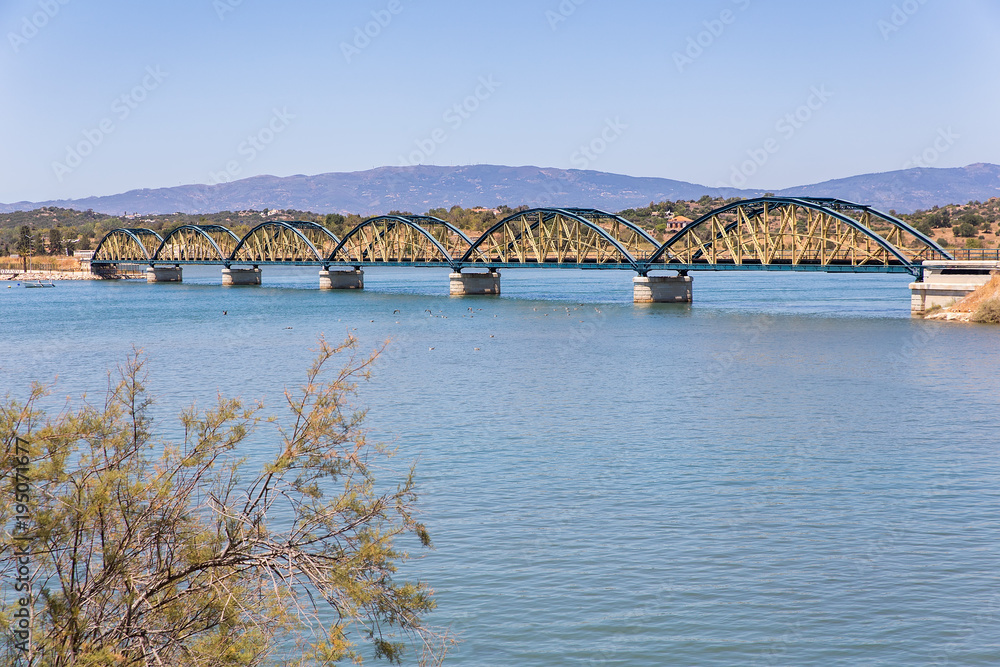 Railway bridge over water in portuguese landscape
