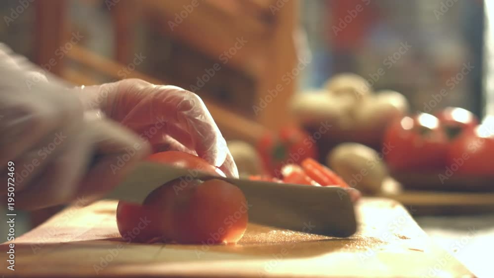 Cutting tomatoes on a cutting board.
Close-up. Slow motion. Focus in.
Female hands cut the tomato into slices. Cutting tomatoes on a cutting board.
Close-up. Slow motion. Focus in.
Female hands cut the tomato into slices.