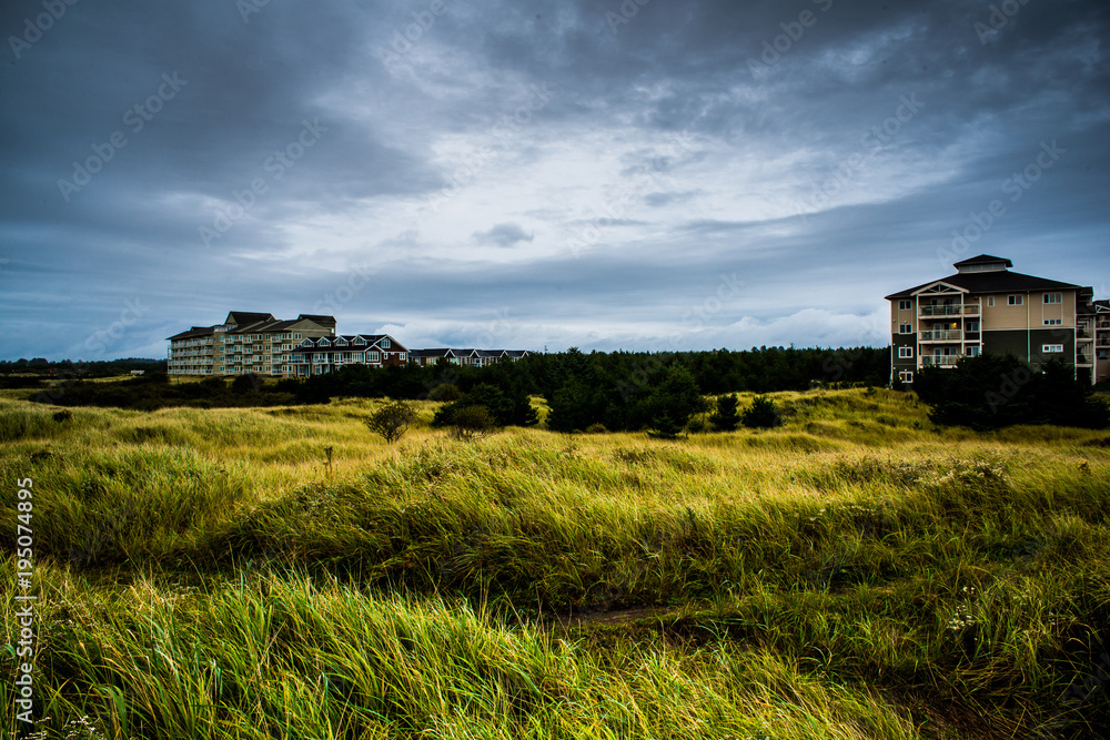 A Hotel Or Motel In The Back Of A Large Green Grassy Field In The Rain With More Storm Coming In Long Beach Washington