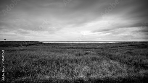 Canvas Print The Ocean At The Edge Of The Horizon Is Like A Tread To The Dark Sky Above And T