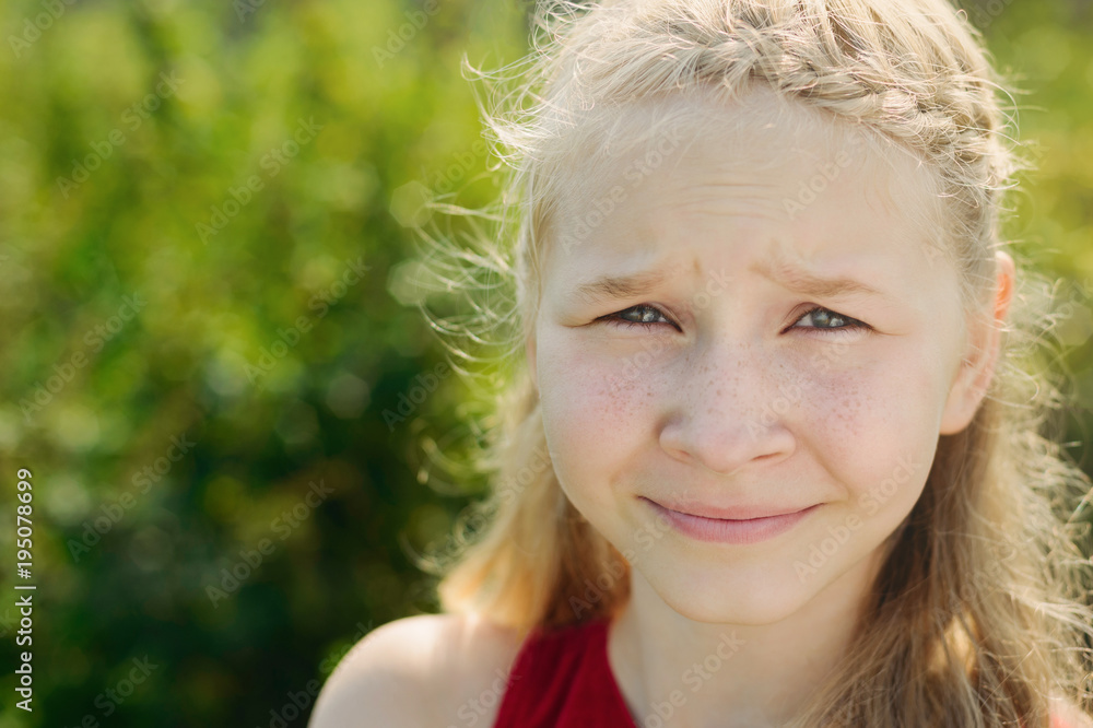 portrait of cute little blonde caucasian girl on green grass background portrait of cute little blonde caucasian girl on green grass background