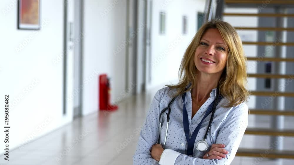 Portrait Of Female Doctor Walking Towards Camera And Smiling Portrait Of Female Doctor Walking Towards Camera And Smiling