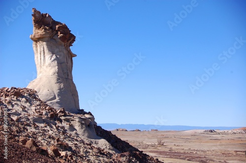 Strange rock formations in badlands with bright blue sky in the Bisti De Na Zin wilderness in Northern New Mexico