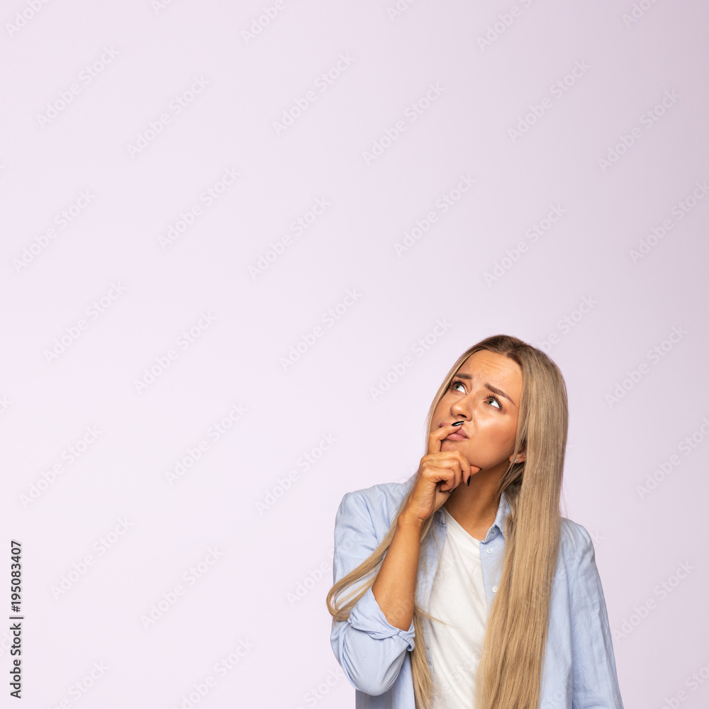 Closeup studio portrait of pensive young woman thinking, pondering and looking up at place for advertising or copy space. Face expressions, emotion concept Closeup studio portrait of pensive young woman thinking, pondering and looking up at place for advertising or copy space. Face expressions, emotion concept